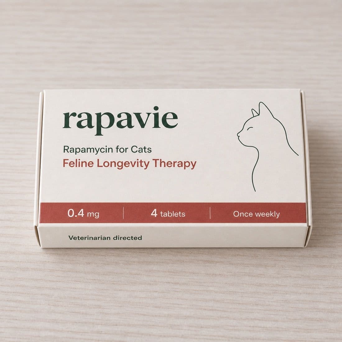 The Rapavie cat carton on a pale wooden surface, showing 0.4 mg, four tablets, once weekly